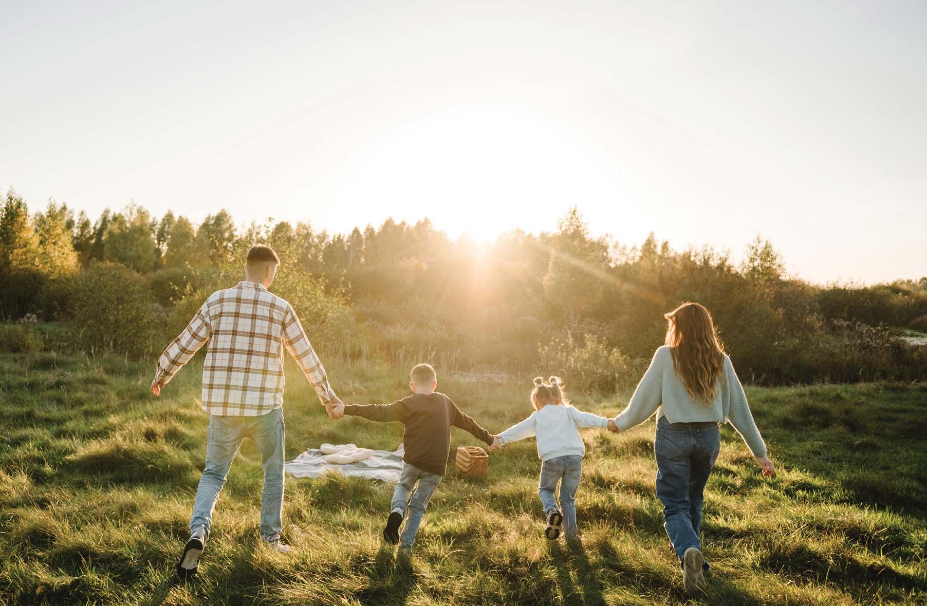 Family walking through a sunlit field in Hillsburgh, Ontario