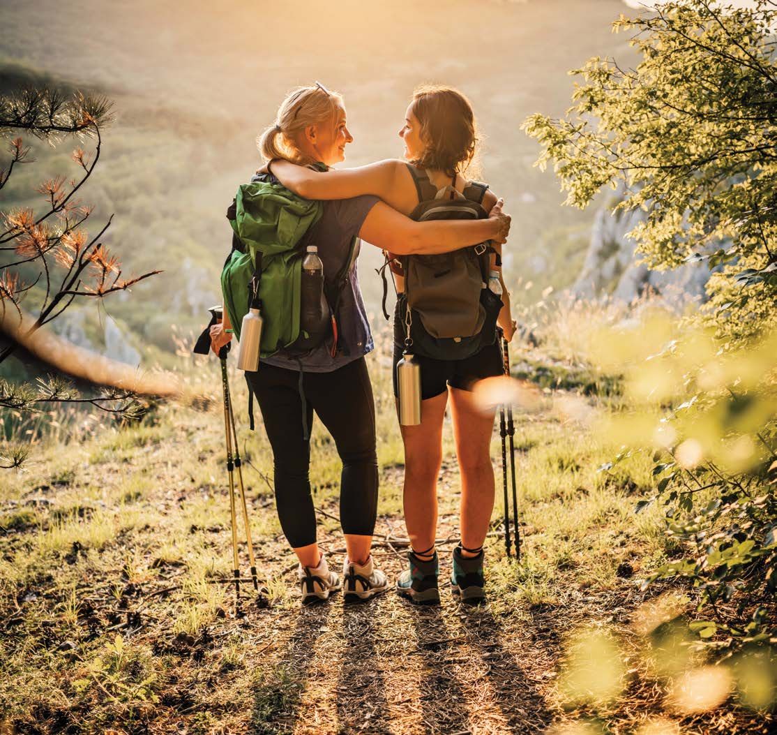 Friends hiking a trail at golden hour