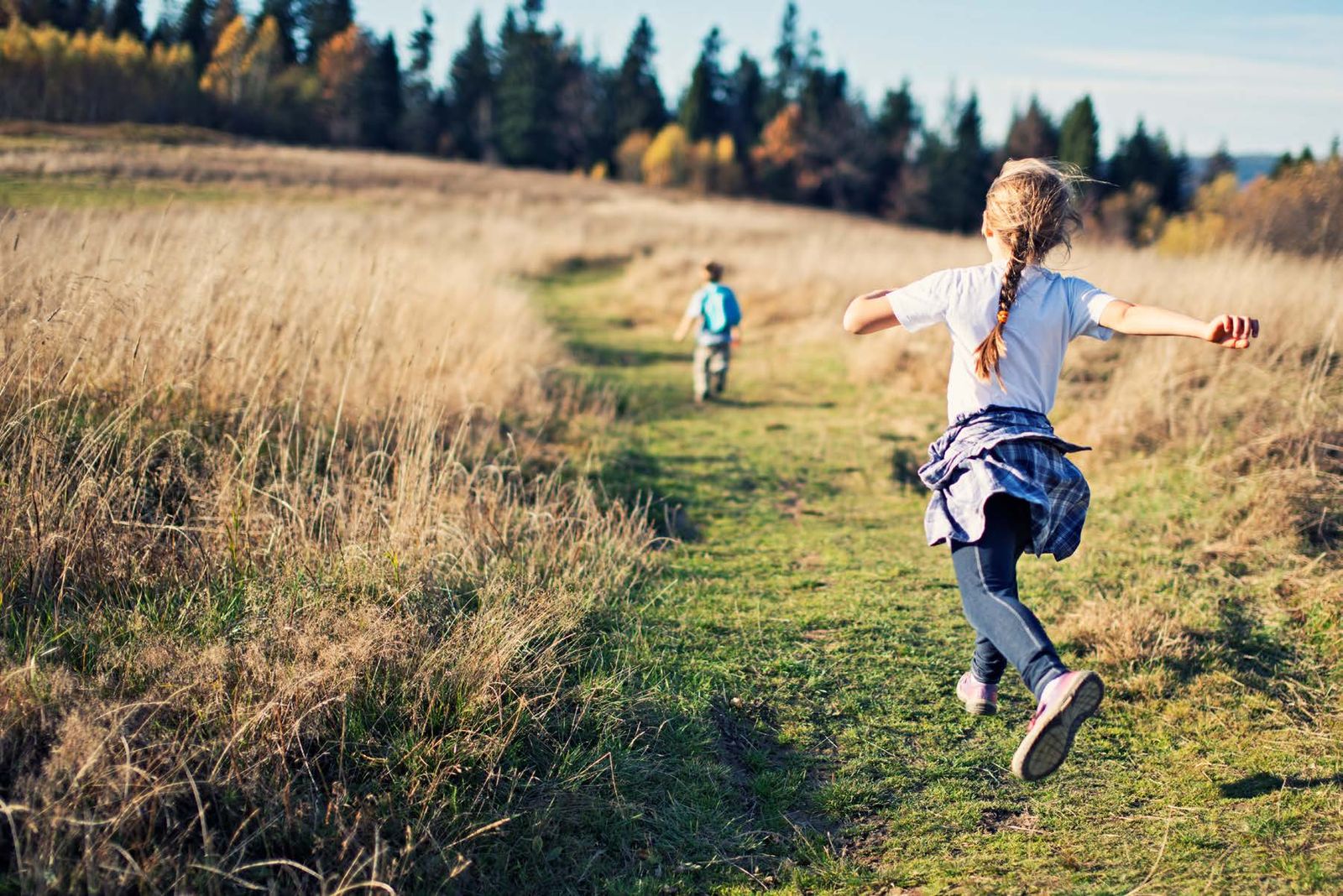 Child running along a country path